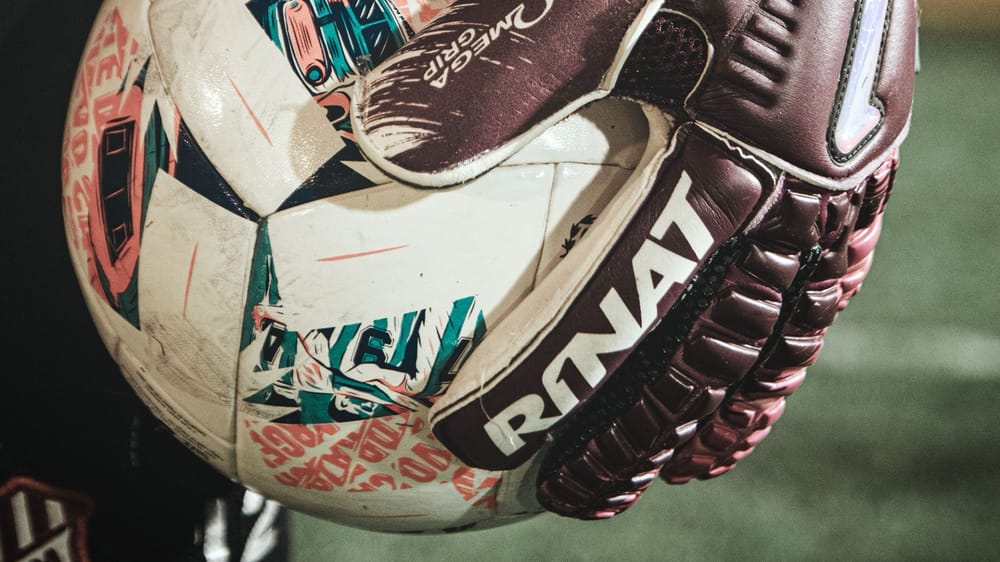 Generic goalkeeper gloves ball pexels